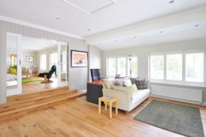 Luxury home interior with hardwood floors and large windows.