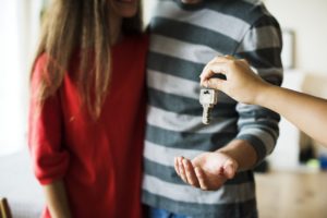 Young couple accepting the keys to their new home.