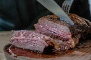 A person slicing bbq