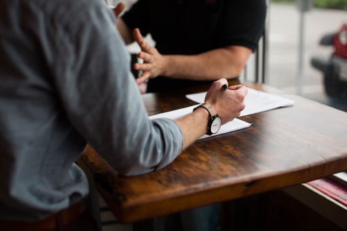 People talking at a table.