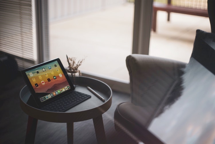 An iPad sitting on a coffee table.