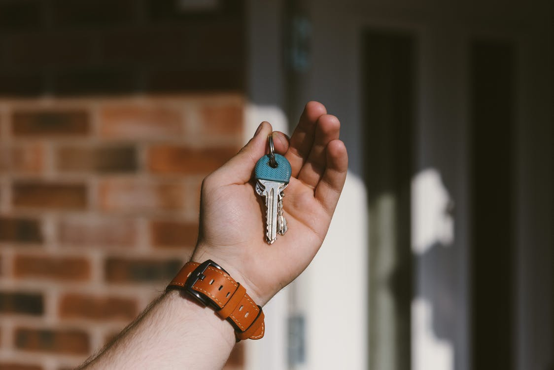 A buyer holding up keys to a home.