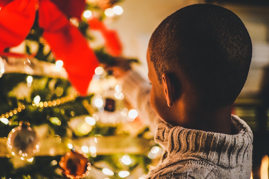 Child near a Christmas tree at WinterFest